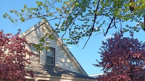 A two-story house with a front porch and a white picket fence. - Charming 4BR Craftsman Family Home in Emery (Emery)
