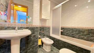 Bidet, towels, soap, toilet paper