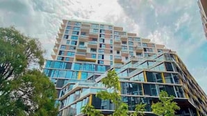 A multi-story building with a modern architectural design, featuring a mix of glass and concrete facades. - 7 Cool studio at the best zone (Ciudad de Guatemala)