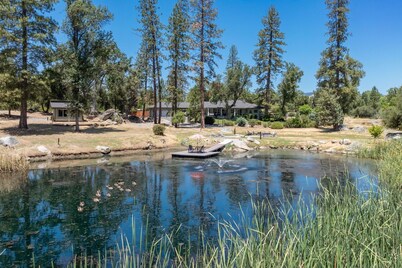 Riverbend Retreat  5-bedroom villa with spa, pond, gym, and private bar.