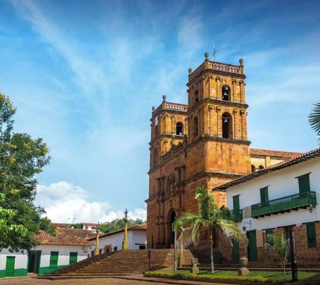 A historic building with a bell tower, steps leading up to it, and a clear sky.