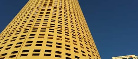 A tall, cylindrical building with a grid of windows.
