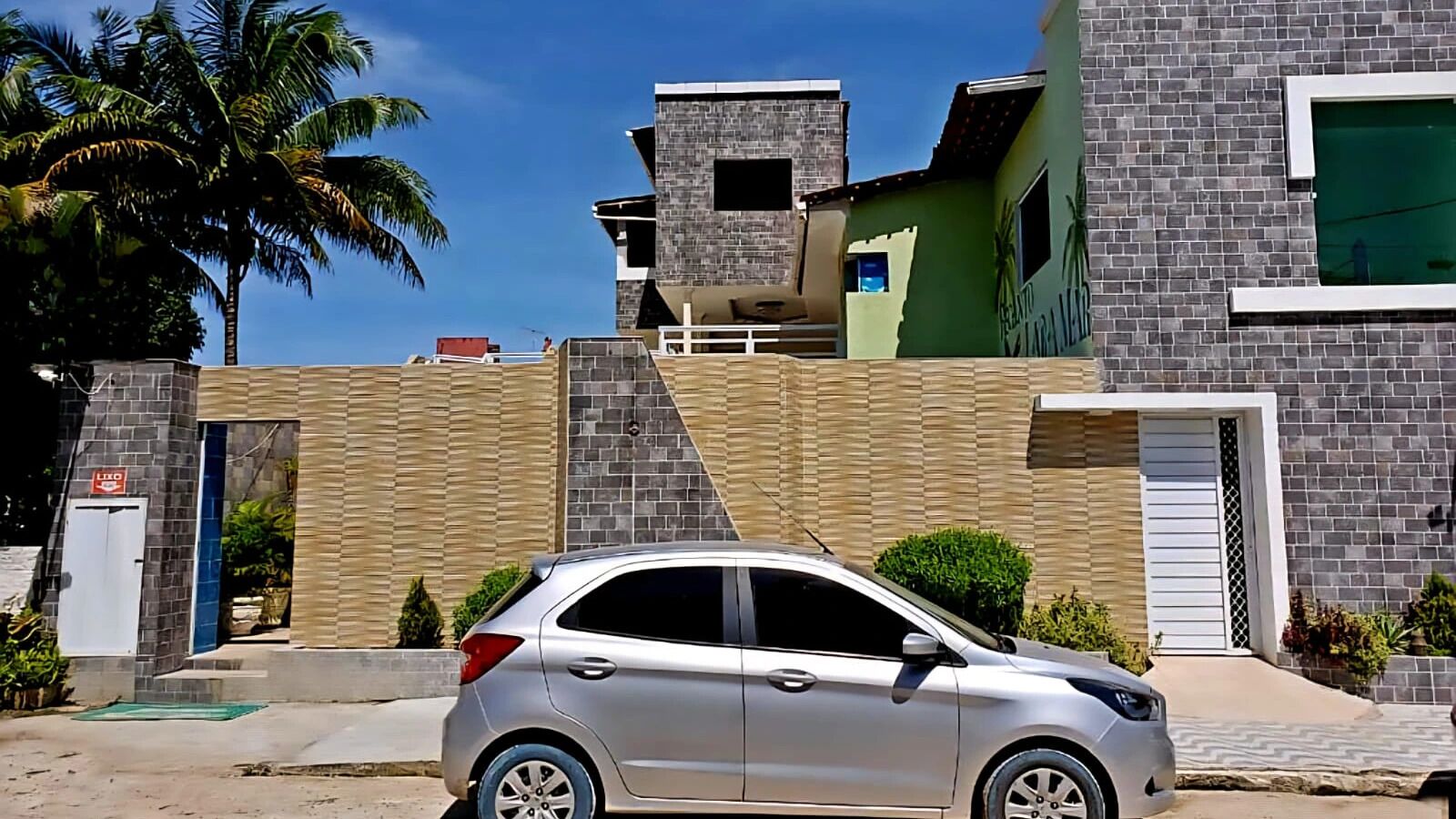 A modern building with a car parked in front.