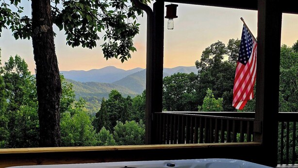 A hot tub with a view of mountains and an American flag. - Mountain Views! Family-friendly, 4 BR + Bunkroom, NEW Hot Tub, Firepit, Gameroom (Hiawassee)