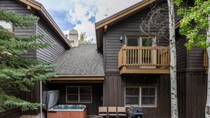 A house with a hot tub, outdoor seating, and a barbecue grill. - Scenic Location: Beautiful Townhome, 5 min to Base, Private Hot Tub, Walk to restaurants! (Park City)