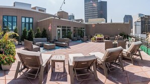 A rooftop patio with outdoor furniture, a pool, and city views. - Modern 1B in Heart of Downtown • Pool & Spa • Gym (Cleveland)
