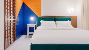 A modern hotel room with a bed, a nightstand, a wall with geometric patterns, and a hanging light fixture. - Three Bedroom Colorful & Exotic Flat in Alrabie (Riyadh)