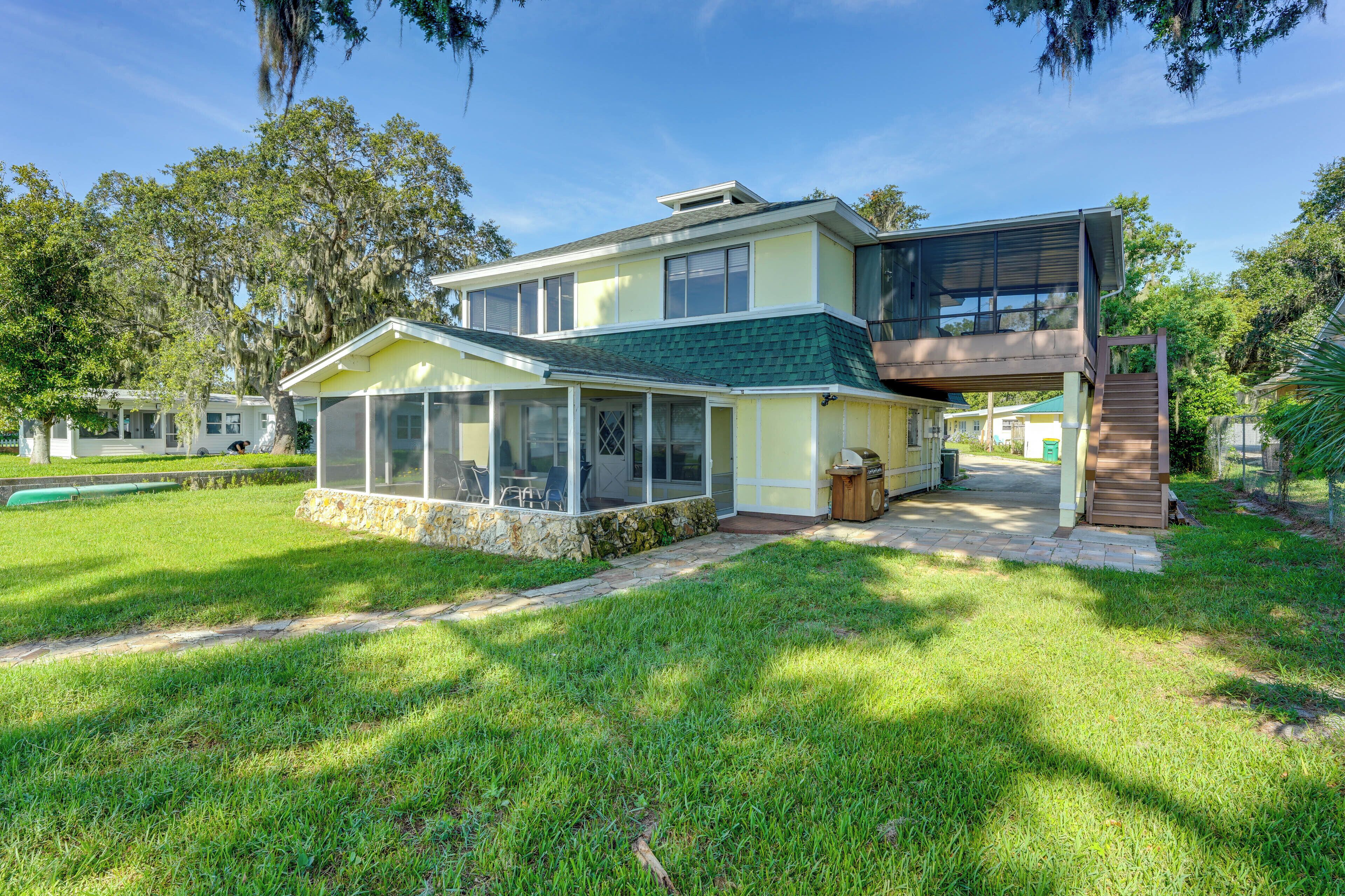 A two-story house with a covered patio and a visible staircase leading to the upper level.