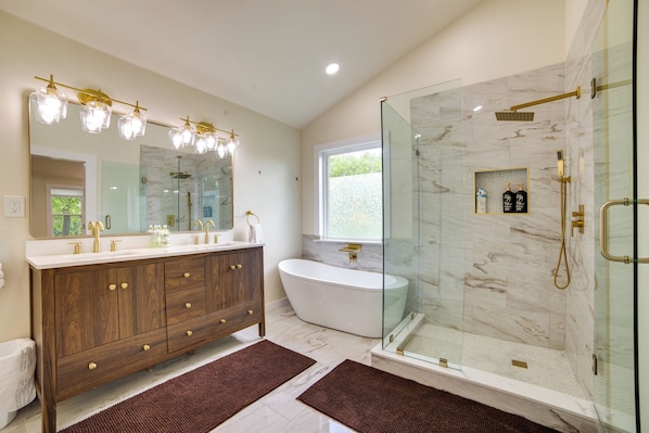 A modern bathroom with a freestanding bathtub, a glass-enclosed shower, and a vanity with a large mirror. - Blue Ridge Retreat on 10-acre Farm: Rural Reset! (Blue Ridge)