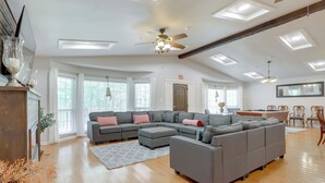 A spacious living room with a large sectional sofa, a ceiling fan, and skylights. - Ideal for Reunions & Retreats: Brooks Getaway! (Brooks)