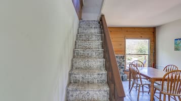 A staircase with patterned steps leading to a wooden door.