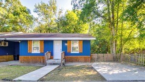 A single-story house with a blue exterior and wooden trim, a front porch, and a fenced backyard. - 6 Mi to Percy E Quin State Park: Mccomb Home! (McComb)