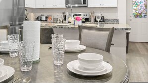 A modern kitchen with white cabinets, stainless steel appliances, and a granite countertop. - Modern 3BR Home in San Antonio (San Antonio)