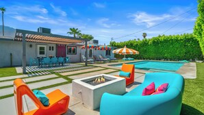 A backyard with a pool, outdoor furniture, and a fire pit. - Mountain Views, Bocce Ball, and Poolside Bliss—PS Desert View Has It All! (Palm Springs)