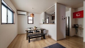 A modern kitchen with a dining area, wooden flooring, and a hanging pendant light. - 福助Tofu   OsakaTsuruhashi 5mins JRloop Direct Nipponbashi;Namba;Nara;USJ;Tennoji  (Ikuno-ku Tsuruhashi)
