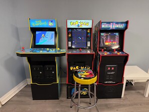 Tres máquinas de videojuegos arcade: 'The Simpsons', 'Pac-Man' y 'Midway Mortal Kombat'.
