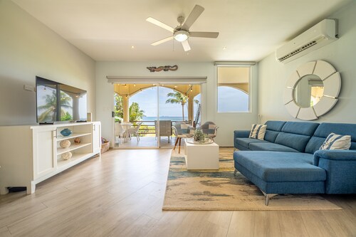 Tranquil beachfront condo with pool, balcony sunset views & fast Wi-Fi