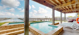 Stunning bay front home with fishing pier, large deck, & private pool