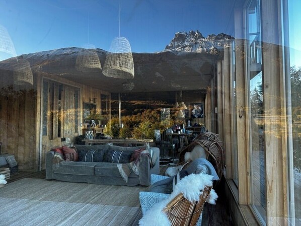 A modern interior with a sofa, chairs, and a dining area.