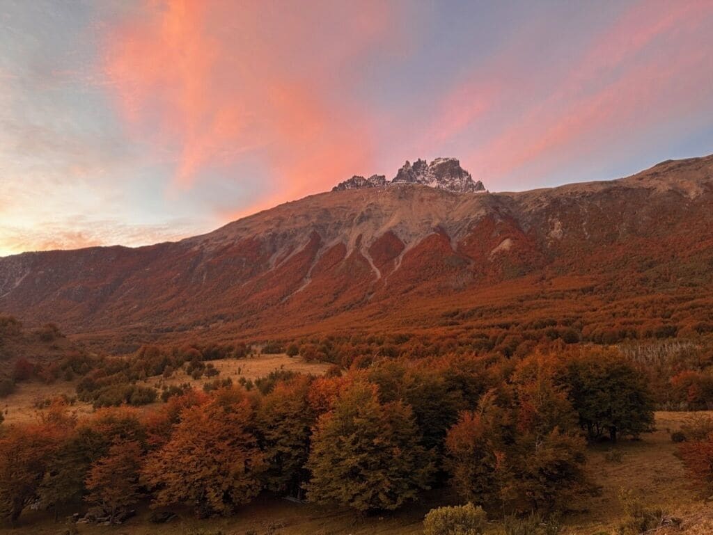 A mountainous landscape with autumn foliage and a clear sky.