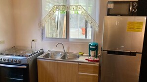 A compact kitchen with a stove, sink, and refrigerator. - JOY & PEACE HOUSE come to enjoy our brand new house . (Tela)