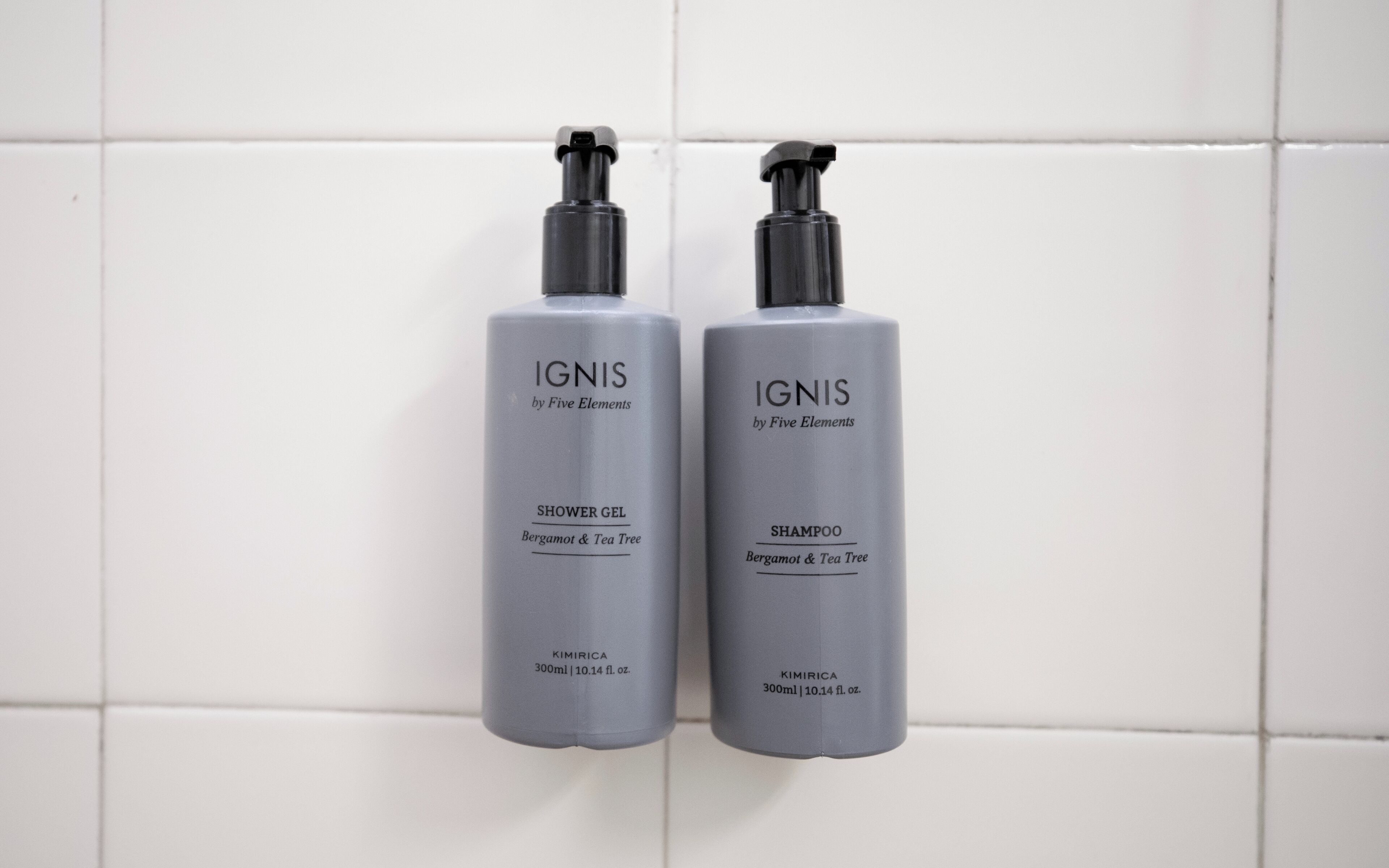 Two bottles of IGNIS by Five Elements shower gel and shampoo, both labeled with the same ingredients and size.