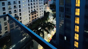A high-rise building with multiple floors, large windows, and a modern architectural design. - One Palm Tree Villas (Pasay)