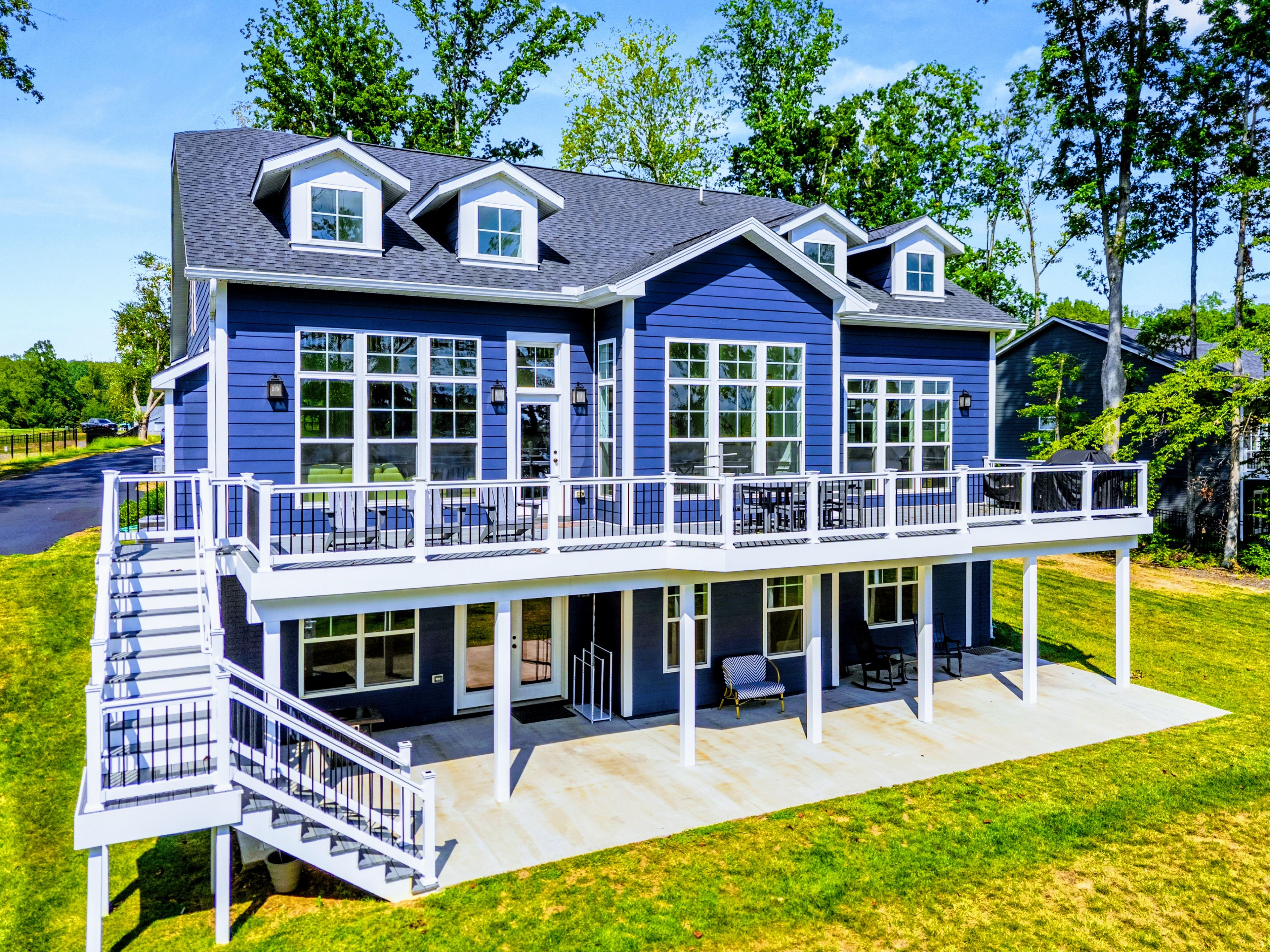 A two-story house with a balcony and a covered porch.
