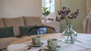 A dining table with two cups and a vase of flowers. - La Finestra sul Mare - Apartment with a view (Gabicce Mare)