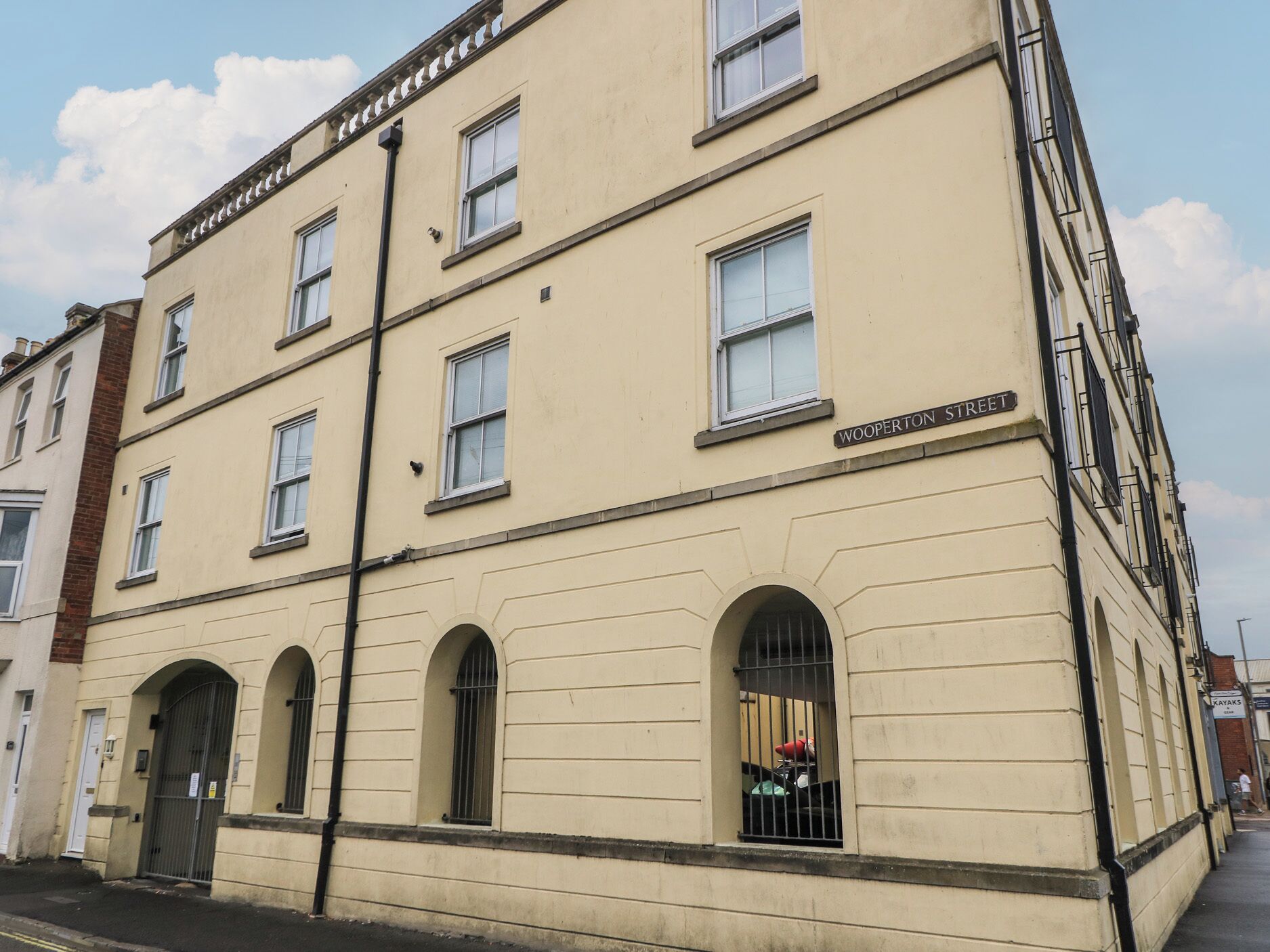 A building with multiple windows and a sign reading "WOOPERTON STREET".
