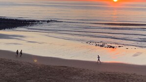 A beach scene with a sunset, calm sea, and people walking. - Bargara Haven
Welcome to your personal oasis: Coastal calm blends with style. (Bargara)