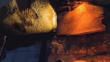 A stone building with a large, illuminated sign reading "HOSPITAL."