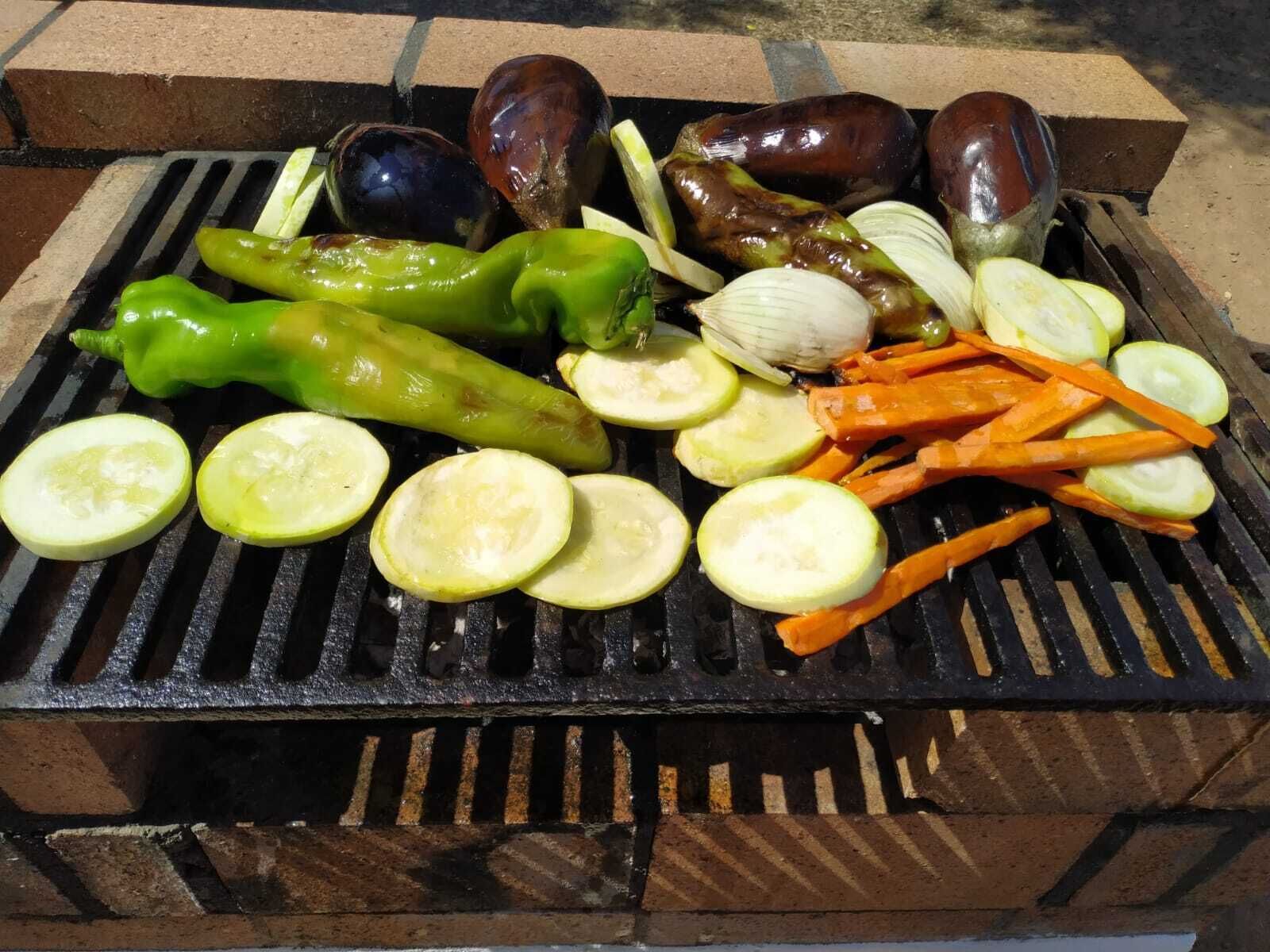 A grill with various vegetables and eggplants.