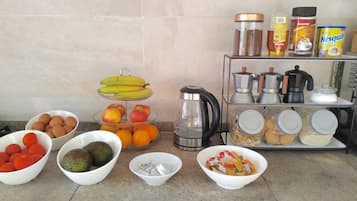 Una encimera de cocina con diversos alimentos y electrodomésticos.