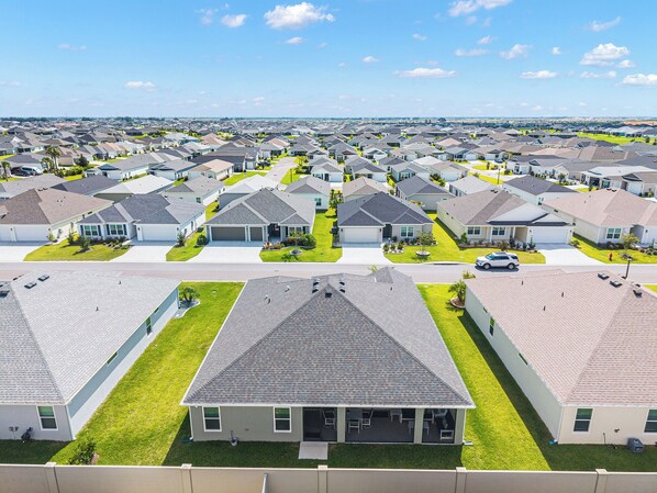 A residential area with multiple houses, each with a garage and a lawn.