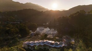 A residential area with a large building featuring multiple roofs and a central courtyard.