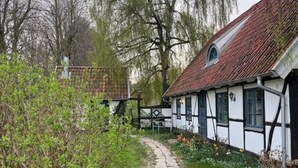 A traditional half-timbered house with a stone pathway leading to the entrance. - Renovated Half-timbered house in Österlen built 2006 (Skåne län)