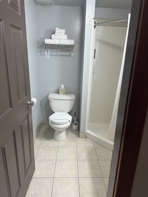 Shower, hair dryer, slippers, towels
