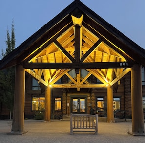 A wooden lodge with a covered entrance and a number sign '801'.