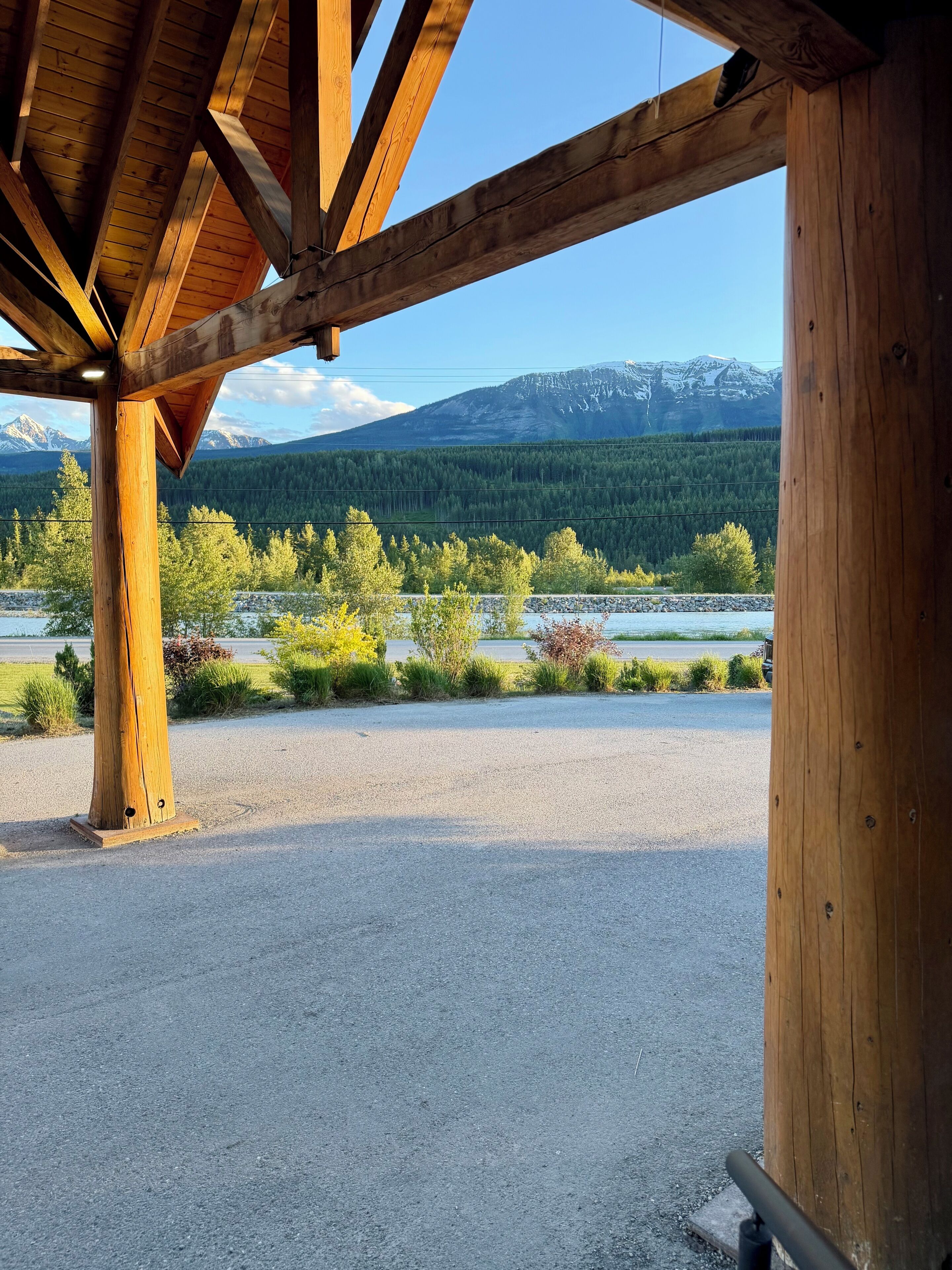 A wooden structure with a view of a mountainous landscape and a body of water.