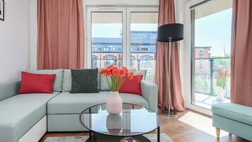 Comfort Apartment | Living area | 50-inch Smart TV with cable channels