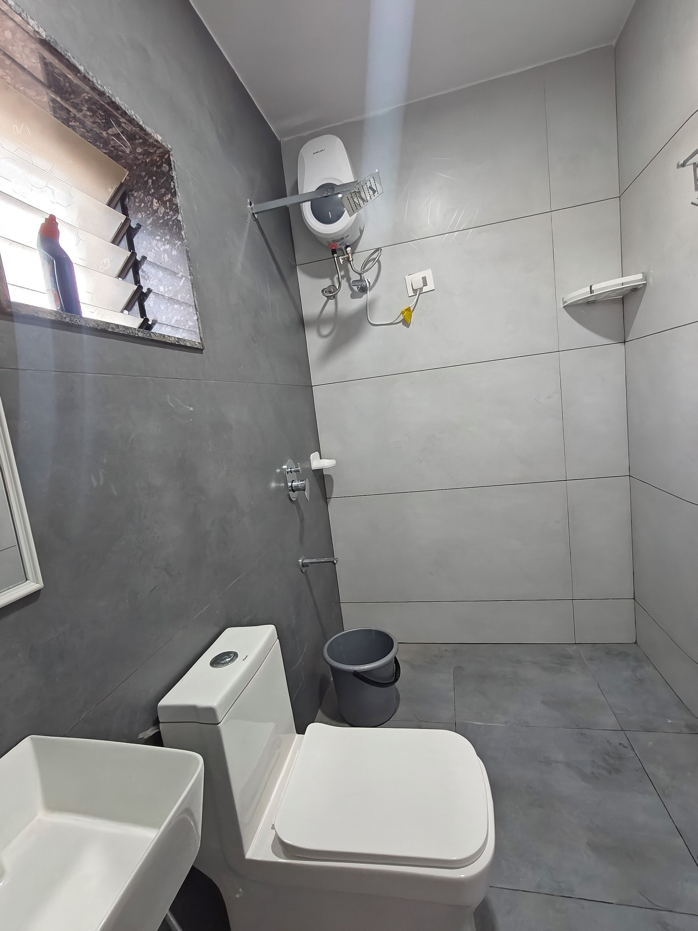 A modern bathroom with a toilet, bidet, and shower.