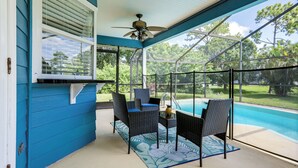 A covered patio area with a pool, featuring wicker furniture and a ceiling fan. - 6 Mi to St Lucie River: Family Home w/ Patio! (Port Saint Lucie)