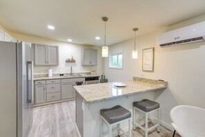 A modern kitchen with granite countertops, stainless steel appliances, and pendant lighting. - 'the Garden Cottage' w/ Yard & Views in Erwin! (Erwin)