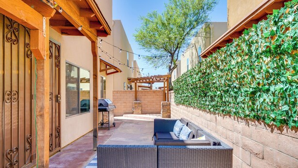 An outdoor patio with wicker furniture, a barbecue grill, and a pergola. - Southwestern Chic! Tucson Retreat w/ Private Patio (Tucson)