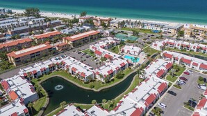 A resort with multiple buildings, a central pool, and a marina.