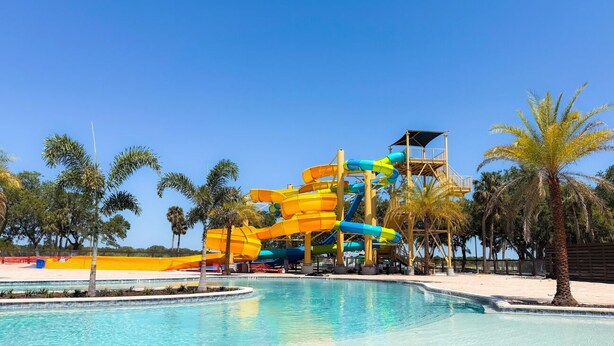 A water park with a multi-level water slide and a pool. - Ideal Condo in River Ranch • Across from the water park and near the rodeo (River Ranch)
