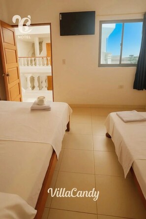 Family Triple Room, Partial Ocean View | Blackout drapes, soundproofing, iron/ironing board, free WiFi