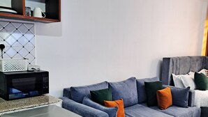 A modern kitchen with a stove, microwave, and a small dining area. - Cozy and Affordable  studio in Kasarani, Seasons,near Thika Road, Nairobi (Nairobi)