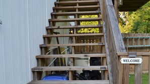 A wooden staircase with a 'WELCOME' sign, leading to a deck area. - Charming studio in peaceful Long Beach with AC (Long Beach)